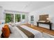 Spacious main bedroom with hardwood floors, console table and windows with views of the outdoors at 23 Walthall Ne St, Atlanta, GA 30317