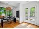 Stylish office space featuring hardwood floors, a modern chandelier, and large windows offering scenic views at 23 Walthall Ne St, Atlanta, GA 30317