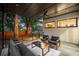 Relaxing covered patio with stylish seating and a view of the lush, green backyard at 23 Walthall Ne St, Atlanta, GA 30317