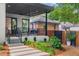 Inviting covered patio with modern furniture and a view of the landscaped yard, perfect for outdoor relaxation at 23 Walthall Ne St, Atlanta, GA 30317