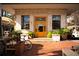 Charming restaurant exterior with a yellow door, brick facade, and outdoor patio seating under a sunshade at 23 Walthall Ne St, Atlanta, GA 30317
