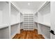 Walk-in closet featuring custom shelving and hardwood floors perfect for organization at 23 Walthall Ne St, Atlanta, GA 30317