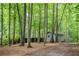 Private wooded backyard with mature trees, outbuilding, and lush landscaping creates tranquil retreat at 3788 Westwick Nw Ct, Kennesaw, GA 30152