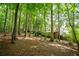 Expansive backyard with outbuilding, house with covered porch, and surrounded by mature trees at 3788 Westwick Nw Ct, Kennesaw, GA 30152