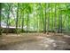 Expansive backyard surrounded by mature trees featuring house and outbuilding on property at 3788 Westwick Nw Ct, Kennesaw, GA 30152