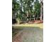 The backyard is partially shaded by tall trees, with a mix of manicured lawn and natural wooded areas at 3788 Westwick Nw Ct, Kennesaw, GA 30152