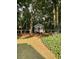 The backyard is a mix of green lawn and groundcover, featuring a charming playhouse at 3788 Westwick Nw Ct, Kennesaw, GA 30152