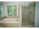 Bathroom featuring a tub, walk-in shower, and tile accents at 3788 Westwick Nw Ct, Kennesaw, GA 30152