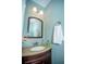 Bathroom features a granite countertop, classic fixtures, and wainscoting for a sophisticated look at 3788 Westwick Nw Ct, Kennesaw, GA 30152