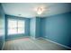 Bedroom features carpeted floors, a ceiling fan, and large windows for natural light at 3788 Westwick Nw Ct, Kennesaw, GA 30152