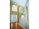 Bright foyer featuring hardwood floors, a staircase, and a large arched window for natural light at 3788 Westwick Nw Ct, Kennesaw, GA 30152