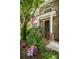 Inviting front porch with colorful flowers, decorative plants, and an American flag at 3788 Westwick Nw Ct, Kennesaw, GA 30152