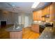 Bright kitchen features granite countertops, wooden cabinets, stainless steel appliances and an island sink at 3788 Westwick Nw Ct, Kennesaw, GA 30152