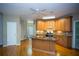 Kitchen with stainless appliances, granite counters, island, and hardwood floor at 3788 Westwick Nw Ct, Kennesaw, GA 30152