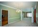 Bright room with adjoining rooms, windows, carpet, and staircase at 3788 Westwick Nw Ct, Kennesaw, GA 30152