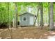 Outbuilding with a door and window, surrounded by trees, provides extra storage and utility at 3788 Westwick Nw Ct, Kennesaw, GA 30152