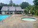 Community pool with hot tub, tables, chairs and umbrellas for a resort-like experience at 3788 Westwick Nw Ct, Kennesaw, GA 30152