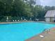 Large community pool with lounge chairs and umbrellas for residents' enjoyment at 3788 Westwick Nw Ct, Kennesaw, GA 30152