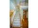 Staircase with wooden handrail and white spindles leads to upper level at 3788 Westwick Nw Ct, Kennesaw, GA 30152
