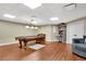 Finished basement game room with pool table, vinyl plank flooring and built-in bookcases at 511 Baxter Way, Marietta, GA 30064