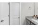 Bright bathroom with sleek countertops, neutral walls, and modern fixtures with bright lights over the vanity at 9122 Golfview Cir, Covington, GA 30014