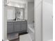 Bright bathroom featuring modern fixtures, a soaking tub, and gray cabinets with stunning granite countertops at 9122 Golfview Cir, Covington, GA 30014