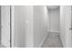 Hallway showcasing neutral-colored walls, plush carpet, and well-lit access to rooms with bright white doors at 9122 Golfview Cir, Covington, GA 30014