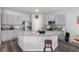 Modern kitchen with an island, stainless appliances, and grey cabinets at 9122 Golfview Cir, Covington, GA 30014