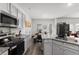Modern kitchen with granite counters, stainless appliances, and an adjoining dining area at 9122 Golfview Cir, Covington, GA 30014
