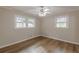 This bedroom is well-lit with two windows and features hardwood floors at 4485 Canary Ct, Lithia Springs, GA 30122