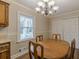 Dining room with a wooden table set for four, featuring natural light and storage space at 4485 Canary Ct, Lithia Springs, GA 30122