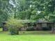 Traditional brick home with a mature tree in the front yard providing shade and curb appeal at 4485 Canary Ct, Lithia Springs, GA 30122