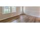 Bright living room with wood-look flooring and a view of the front yard through large windows at 4485 Canary Ct, Lithia Springs, GA 30122