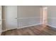 Spacious living room with wood-look floors, white trim and baseboards, and a neutral color palette at 4485 Canary Ct, Lithia Springs, GA 30122