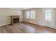 Inviting living room featuring wood-look floors, a decorative fireplace, and abundant natural light at 4485 Canary Ct, Lithia Springs, GA 30122