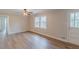 Bright living room featuring hardwood floors, a ceiling fan, and a large window letting in natural light at 4485 Canary Ct, Lithia Springs, GA 30122