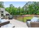 Relaxing outdoor deck with comfortable seating overlooking a green, tree-lined backyard at 6470 Long Island Nw Dr, Atlanta, GA 30328