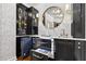 Elegant bar area with black cabinetry, marble countertop, built-in refrigerator and beverage drawers at 6470 Long Island Nw Dr, Atlanta, GA 30328