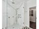 Modern bathroom features a glass enclosed shower with marble surround and a hexagon-tiled floor at 6470 Long Island Nw Dr, Atlanta, GA 30328