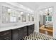 Modern primary bath boasting dual vanities, marble counters, and elegant black and white tile flooring at 6470 Long Island Nw Dr, Atlanta, GA 30328