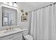 Elegant bathroom featuring a marble countertop vanity with a sleek mirror, toilet and a glass-enclosed shower at 6470 Long Island Nw Dr, Atlanta, GA 30328