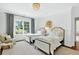 Bright bedroom with two twin beds, a sitting area, and views of the outside, enhancing the room's appeal at 6470 Long Island Nw Dr, Atlanta, GA 30328