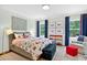 Cozy bedroom with a bed, framed artwork, and navy blue curtains, offering a peaceful retreat at 6470 Long Island Nw Dr, Atlanta, GA 30328