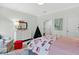 Bright bedroom features a dresser, artwork, and a cozy reading chair, creating a comfortable space at 6470 Long Island Nw Dr, Atlanta, GA 30328