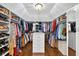 Spacious walk-in closet with custom shelving, storage drawers, and ample hanging space at 6470 Long Island Nw Dr, Atlanta, GA 30328