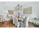 Bright dining room with hardwood floors, statement chandelier, and charming botanical wall art at 6470 Long Island Nw Dr, Atlanta, GA 30328