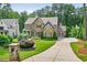 Beautiful stone and brick home with lush landscaping and a curved driveway at 6470 Long Island Nw Dr, Atlanta, GA 30328