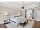 Bright main bedroom featuring a tray ceiling, hardwood floors, and a sliding glass door leading to a Primary bathroom at 6470 Long Island Nw Dr, Atlanta, GA 30328