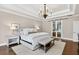 Bright main bedroom featuring a tray ceiling, hardwood floors, and a sliding glass door at 6470 Long Island Nw Dr, Atlanta, GA 30328