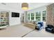 Spacious playroom with a TV, shelving, comfortable seating, and large windows offering natural light at 6470 Long Island Nw Dr, Atlanta, GA 30328